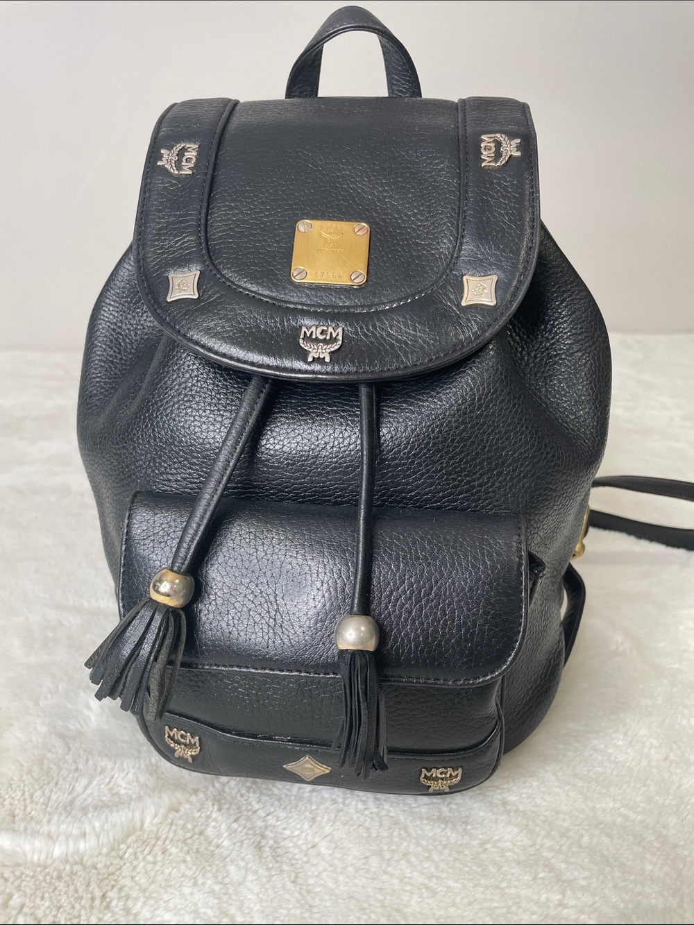 MCM Black Leather Logo Tassel Drawstring Backpack with Gold Accents